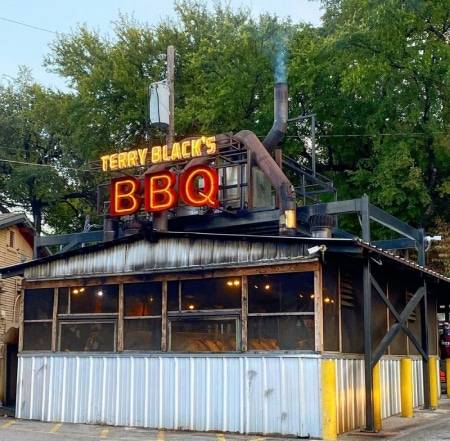 Terry Black's barbecue, in Austin, Texas. Smoke Zapper visible atop the roof.